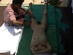Amateur Asian babe has a masseur fingering her cunt outside