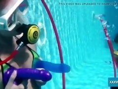 two hot lesbians playing with dildos in the pool