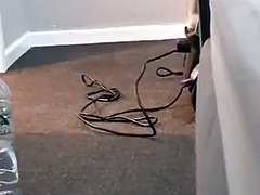 The cleaning lady vacuums the carpet while her boss takes out his cock